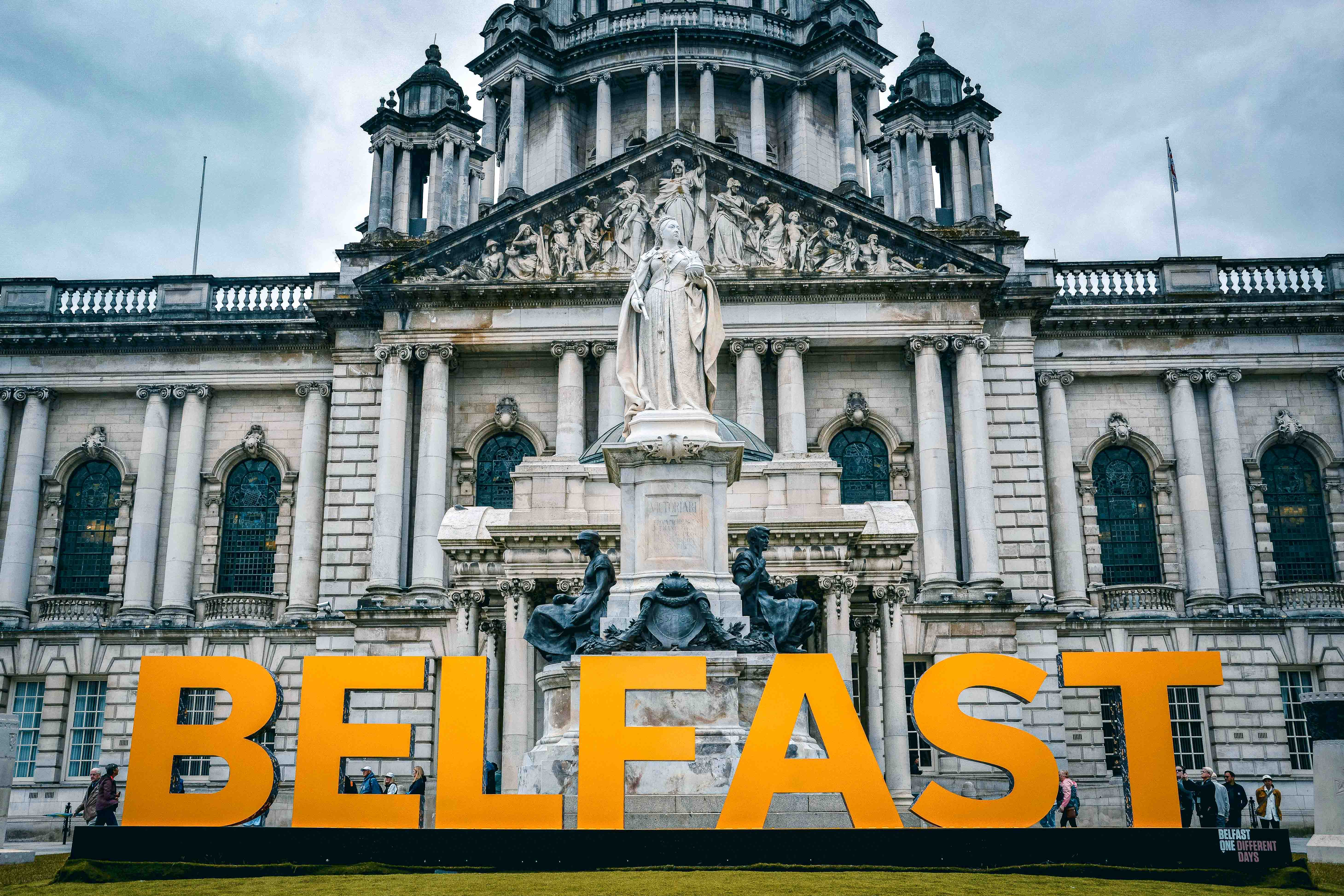 A view of a historic building with a "Belfast" sign in the foreground.
